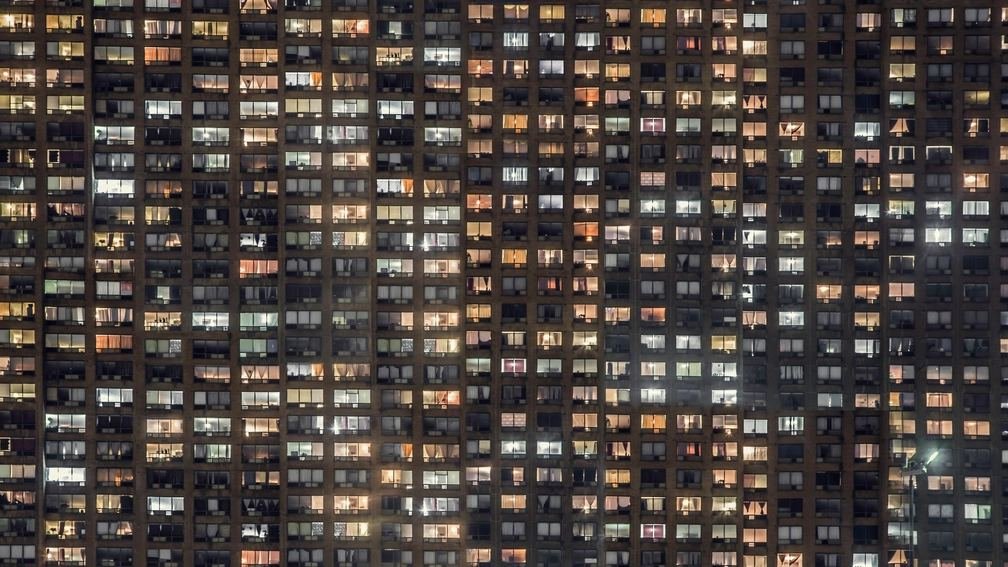 Gece aydınlanmış pencereleriyle çok katlı bir konut bloğu